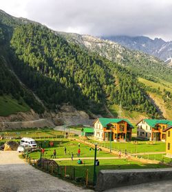 Scenic view of buildings and mountains against sky