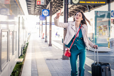 Portrait of young woman standing in city