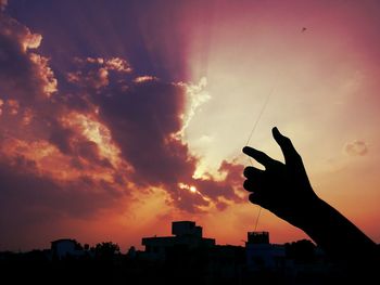 Low angle view of silhouette built structure against sky at sunset