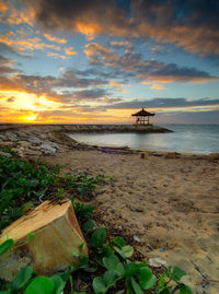Scenic view of beach against sky during sunset