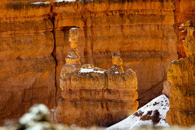 Close up telephoto zoom photo of bryce canyon national park hoodoos lit by sun.