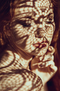 Close-up of sunlight and shadow on beautiful woman face