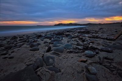 Scenic view of beach against sky during sunset