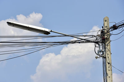 Low angle view of electricity pylon against sky