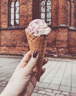 Hand holding ice cream cone