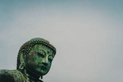 Low angle view of statue against sky