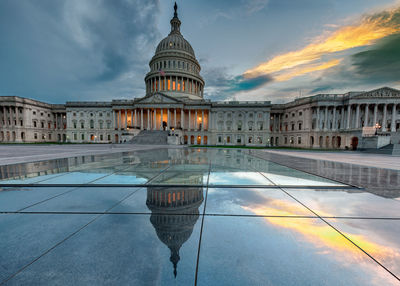 Reflection of united states capitol in water during sunset