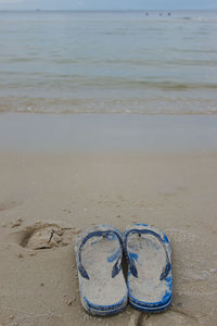 High angle view of shoes on sand at beach