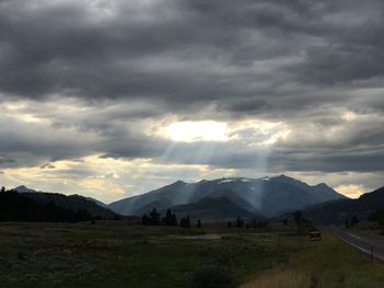 Scenic view of mountains against cloudy sky