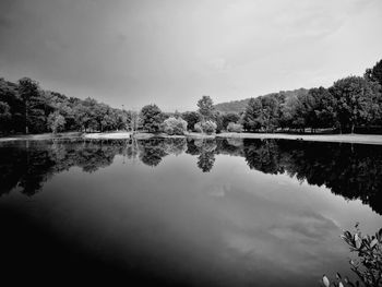 Reflection of trees in lake against sky