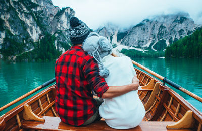 Rear view of man on boat in lake