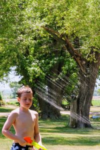 Full length of shirtless boy in water