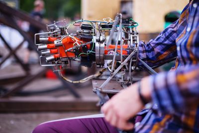 Midsection of man using robotic arm