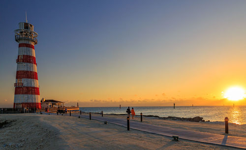 Scenic view of beach against sky during sunset