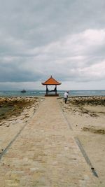 Lifeguard hut on beach against sky