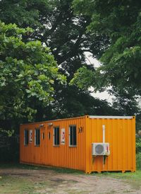 Built structure on field against trees and plants