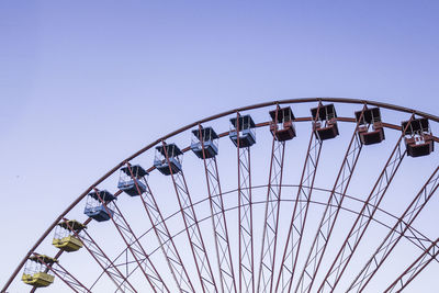 Low angle view of ferris wheel against clear sky