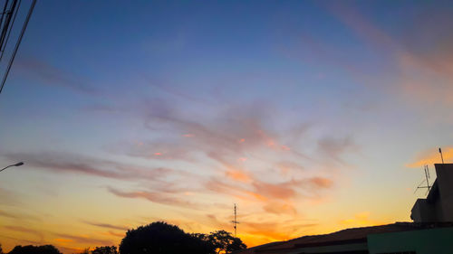 Low angle view of silhouette buildings against sky during sunset