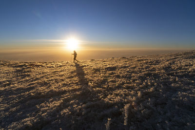 Scenic view of silhouette land against sky during sunset