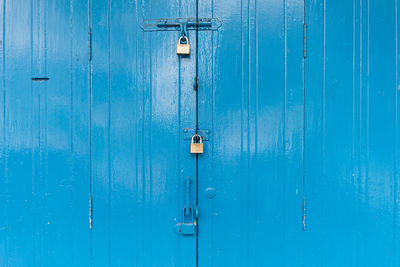 Blue wooden door with the three padlock