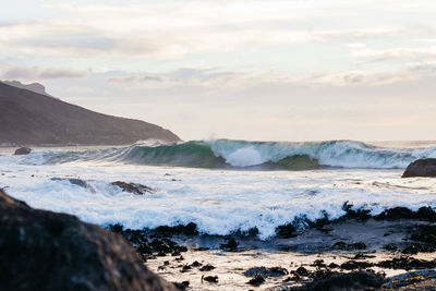 Scenic view of sea waves against sky