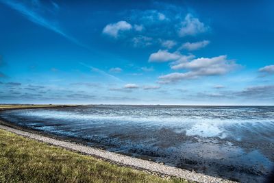 Scenic view of sea against blue sky