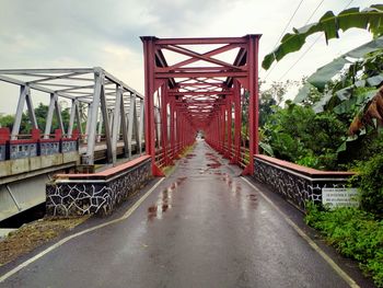 Footbridge over bridge against sky