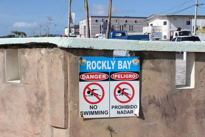 Close-up of sign against sky