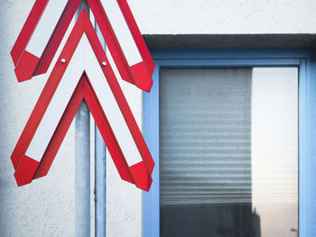 Close-up of stop sign on wall of building