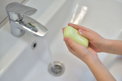 High angle view of woman hand in bathroom