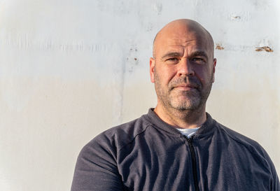 Portrait of middle-aged caucasian man, on white background, looking at camera outdoors.