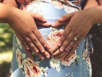 Cropped image of man with hands on pregnant wife abdomen