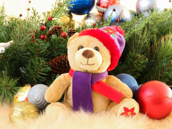 Close-up of teddy bear with christmas decorations on table