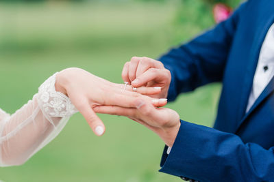 Midsection of couple holding hands