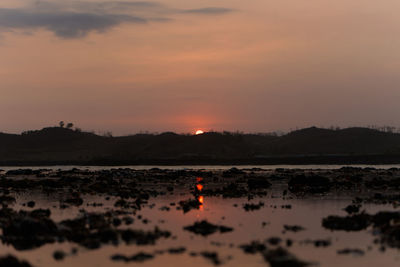 Scenic view of lake against sky during sunset