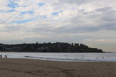 Scenic view of beach and buildings against sky