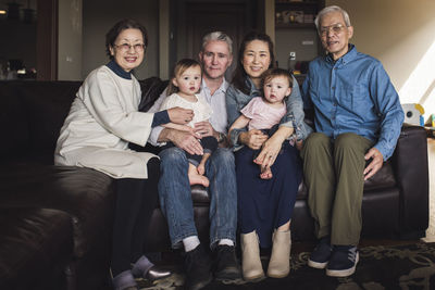 Portrait of multigenerational family smiling on couch