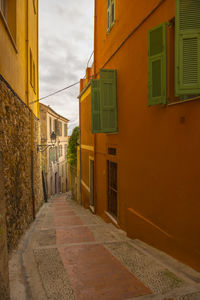 Empty alley amidst buildings in city