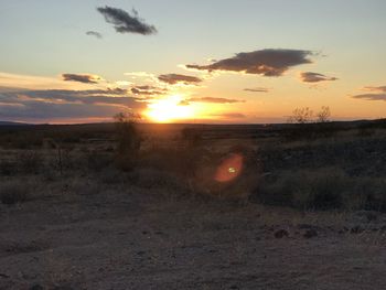 Scenic view of field against sky during sunset