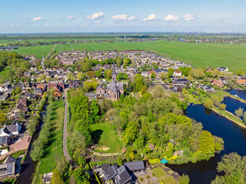 High angle view of townscape by sea against sky