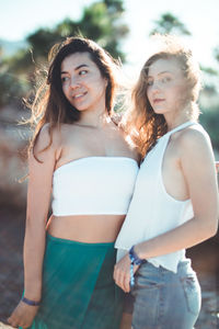 Portrait of smiling young women standing outdoors