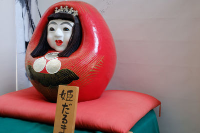 Close-up of japanese figurine on pillow