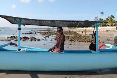 Girl at the beach on boat in bali indonesia 