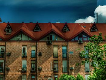 Residential buildings in town against sky