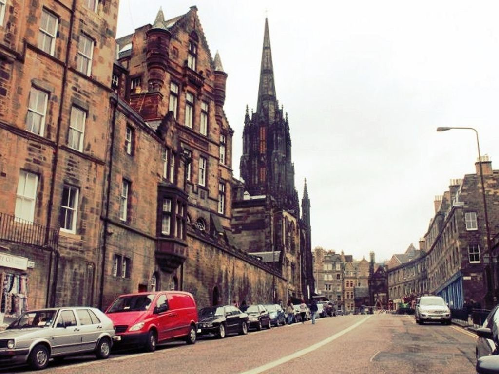 car, transportation, land vehicle, building exterior, architecture, built structure, mode of transport, street, road, city, the way forward, traffic, city street, city life, road marking, vehicle, incidental people, travel, diminishing perspective, parked