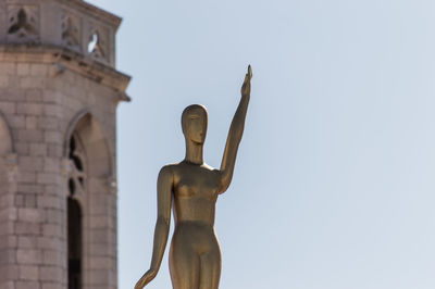 Low angle view of statue against sky