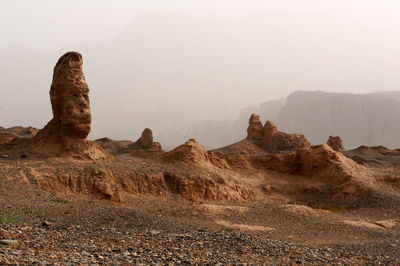 Rock formations on landscape against sky