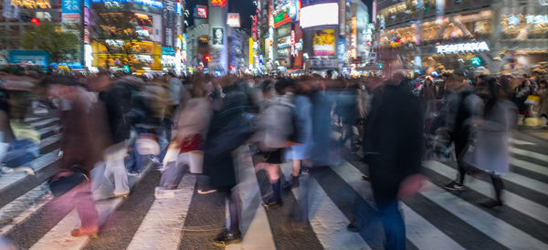 Crowd walking on city street