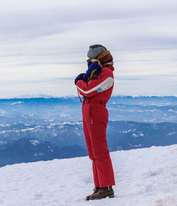 Full length of man standing on snow covered landscape