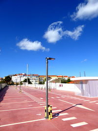 View of empty road against blue sky